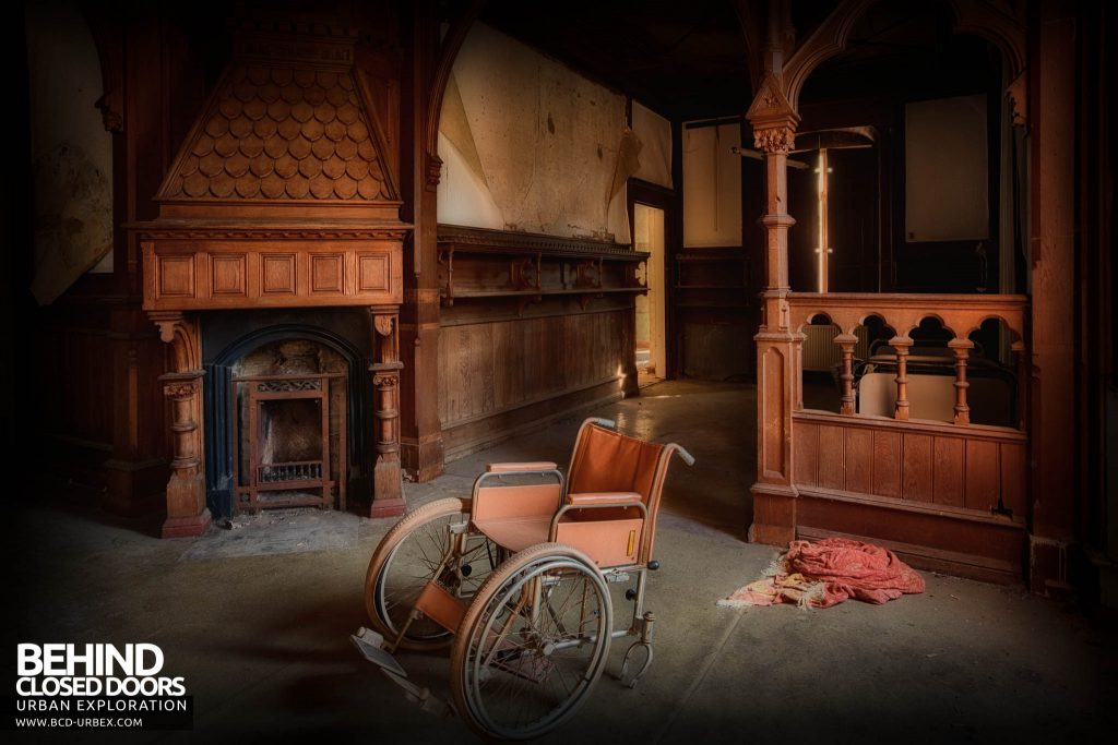Wheelchair Hospital - Wheelchair in a room with a huge fireplace