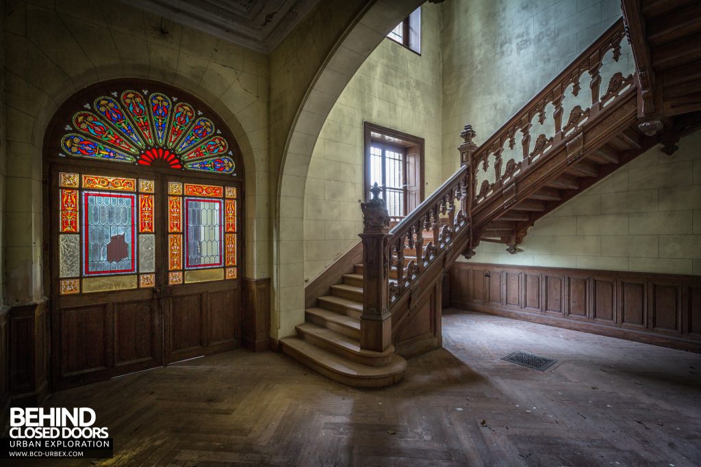 Château Poseidon, France - Staircase and stained glass windows in the front doors