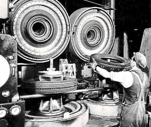 Goodyear Mixing and Retread Plant, Wolverhampton - Archive image of a worker fitting tyres to machinery